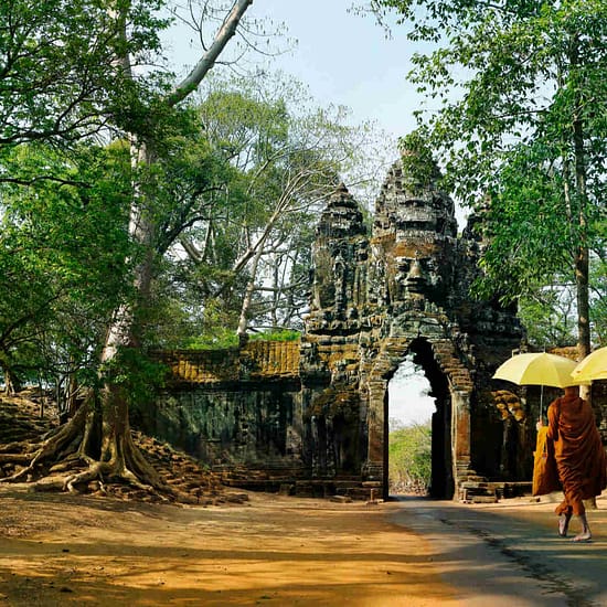 Monks with umbrella walking in Angkor Wat, Cambodia